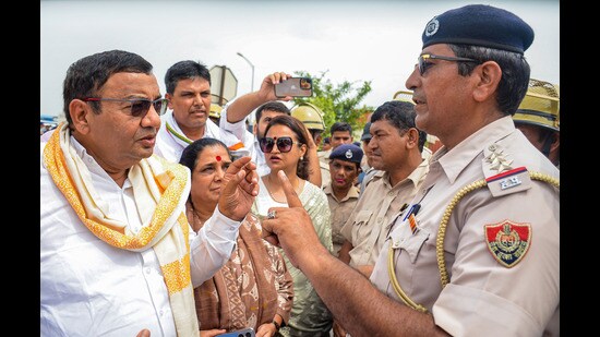 Police stop Aam Aadmi Party (AAP) Haryana state president and MP Sushil Kumar Gupta and other party leaders at the Gurugram-Nuh border near KMP Expressway flyover, in Nuh district on Wednesday. (PTI)