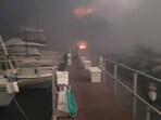 Hawaii Wildfires: Flames are seen near boats docked at Lahaina as wildfires driven by high winds destroy a large part of the historic town of Lahaina, Hawaii.