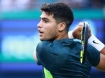 Carlos Alcaraz of Spain hits a shot against Ben Shelton of the United States