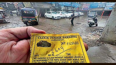 A commuter showing a parking slip of clock tower parking in Ludhiana. (HT PHOTO)