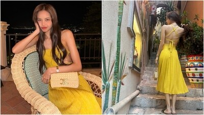 Lisa's sleeveless dress comes in a sunshine yellow shade and features a halter neckline, a backless design with criss-cross ribbon ties, a cut-out on the front, pleated patterns, a midi hem length, and a figure-hugging silhouette. She wore the dress with slip-on sandals, a choker necklace, a sleek watch, a shoulder bag, centre-parted open locks, fuchsia pink lips, winged eyeliner, rouged cheeks, and glowing skin. (Instagram) Lisa's sleeveless dress comes in a sunshine yellow shade and features a halter neckline, a backless design with criss-cross ribbon ties, a cut-out on the front, pleated patterns, a midi hem length, and a figure-hugging silhouette. She wore the dress with slip-on sandals, a choker necklace, a sleek watch, a shoulder bag, centre-parted open locks, fuchsia pink lips, winged eyeliner, rouged cheeks, and glowing skin. (Instagram)