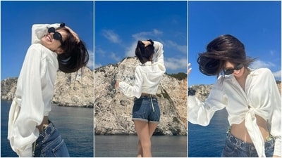 These pictures show her in a white cropped silk-satin shirt featuring knot detail on the front, full-length sleeves with closed cuffs, and a relaxed silhouette. She teamed it with dark blue denim shorts featuring silver embellishments and folded hem. Gold hoop earrings, black tinted sunglasses, open locks, and minimal makeup gave the finishing touch. (Instagram) These pictures show her in a white cropped silk-satin shirt featuring knot detail on the front, full-length sleeves with closed cuffs, and a relaxed silhouette. She teamed it with dark blue denim shorts featuring silver embellishments and folded hem. Gold hoop earrings, black tinted sunglasses, open locks, and minimal makeup gave the finishing touch. (Instagram)