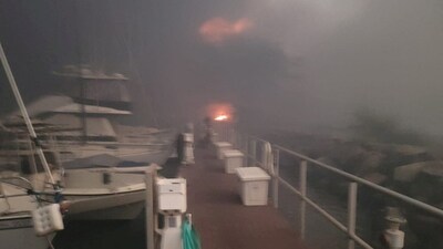 Hawaii Wildfires: Flames are seen near boats docked at Lahaina as wildfires driven by high winds destroy a large part of the historic town of Lahaina, Hawaii. (Reuters)