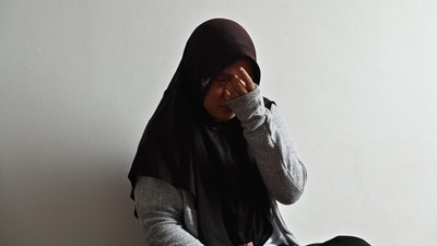 Siti Khotimah wiping away her tears as she speaks about the physical abuse she suffered by her employer while working as a domestic worker, during an interview at a shelter in Jakarta. (AFP) Siti Khotimah wiping away her tears as she speaks about the physical abuse she suffered by her employer while working as a domestic worker, during an interview at a shelter in Jakarta. (AFP)