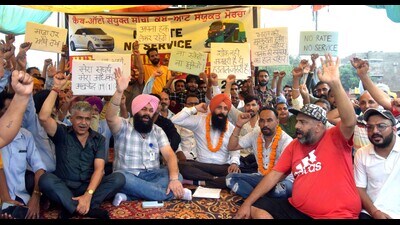 Members of Cab Auto Union Front staging a protest at Rally Ground, Sector 25, Chandigarh, on Thursday. (HT Photo)