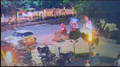 Screengrab of CCTV footage show the chain snatchers near the ice-cream vendor outside GreenArch residential society in Techzone 4. (HT Photo)