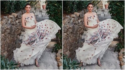 Her full-length gown comes in white colour and has no sleeves, a deep neckline with a U-shaped cut in the middle, a fitted bodice, a flared bottom and white and red roses adorning her gown all over. (Instagram/@aditiraohydari) Her full-length gown comes in white colour and has no sleeves, a deep neckline with a U-shaped cut in the middle, a fitted bodice, a flared bottom and white and red roses adorning her gown all over. (Instagram/@aditiraohydari)