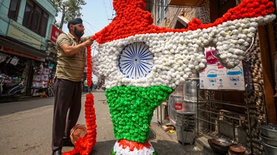An artist decorates a cut-out of the Indian geographical map with tri-colour garlands ahead of Independence Day celebrations in Jammu. (PTI) An artist decorates a cut-out of the Indian geographical map with tri-colour garlands ahead of Independence Day celebrations in Jammu. (PTI)