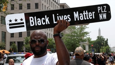 WASHINGTON, DC - JUNE 19: A man holds up a sign of Black Lives Matter Plaza during a Juneteenth celebration event at Black Lives Matter Plaza on June 19, 2023 in Washington, DC. Washingtonians celebrate the newest federal holiday that marks the day on June 19, 1865 when the Emancipation Proclamation was read aloud by Army General Gordon Granger in Galveston, Texas to formally notify previously enslaved people of their freedom. (Getty Images via AFP) WASHINGTON, DC - JUNE 19: A man holds up a sign of Black Lives Matter Plaza during a Juneteenth celebration event at Black Lives Matter Plaza on June 19, 2023 in Washington, DC. Washingtonians celebrate the newest federal holiday that marks the day on June 19, 1865 when the Emancipation Proclamation was read aloud by Army General Gordon Granger in Galveston, Texas to formally notify previously enslaved people of their freedom. (Getty Images via AFP)