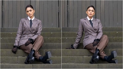 As for accessories, Mrunal styled her look with a black tie tucked into her blazer, dark brown gloves with black frills on her hand and a pair of huge platform heeled boots. (Instagram/@mrunalthakur) As for accessories, Mrunal styled her look with a black tie tucked into her blazer, dark brown gloves with black frills on her hand and a pair of huge platform heeled boots. (Instagram/@mrunalthakur)