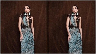 Sobhita decked up in a pastel blue silk gown featuring prints in shades of grey and black. The asymmetrical gown featured transparent netted details at the torso and a black netted bodice in a dramatic halter neckline. (Instagram/@sobhitad) Sobhita decked up in a pastel blue silk gown featuring prints in shades of grey and black. The asymmetrical gown featured transparent netted details at the torso and a black netted bodice in a dramatic halter neckline. (Instagram/@sobhitad)