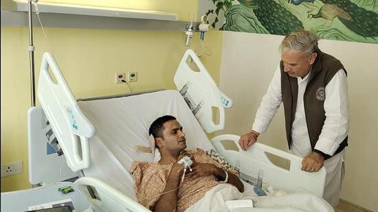 Gurugram MP Rao Inderjit Singh meets a policeman injured in the Nuh violence at Medanta Hospital in Gurugram on Friday. (HT Photo)