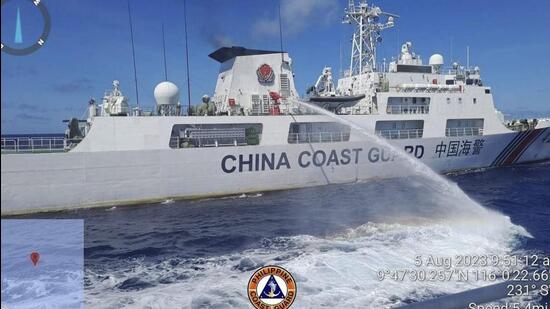 In this handout photo, a Chinese coast guard ship uses water canons on a Philippine Coast Guard ship near the Philippine-occupied Second Thomas Shoal, South China Sea as they blocked its path during a re-supply mission on Aug 5 (AP)