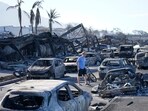 A man walks through wildfire wreckage Friday, Aug. 11, 2023, in Lahaina, Hawaii.  Hawaii emergency management records show no indication that warning sirens sounded before people ran for their lives from wildfires on Maui that wiped out a historic town. (AP/PTI)(AP08_12_2023_000001B)