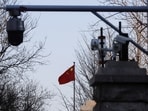 A Chinese flag is seen near surveillance cameras outside the Beijing No. 2 Intermediate People's Court. 