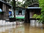 A man looks out from his house in a flooded area following monsoon rains in Bago township, Bago region, A man looks out from his house in a flooded area following monsoon rains in Bago township, Bago region,