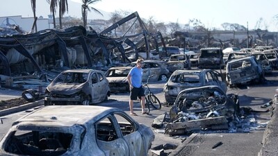 A man walks through wildfire wreckage Friday, Aug. 11, 2023, in Lahaina, Hawaii. Hawaii emergency management records show no indication that warning sirens sounded before people ran for their lives from wildfires on Maui that wiped out a historic town. (AP/PTI)(AP08_12_2023_000001B) (AP) A man walks through wildfire wreckage Friday, Aug. 11, 2023, in Lahaina, Hawaii. Hawaii emergency management records show no indication that warning sirens sounded before people ran for their lives from wildfires on Maui that wiped out a historic town. (AP/PTI)(AP08_12_2023_000001B) (AP)