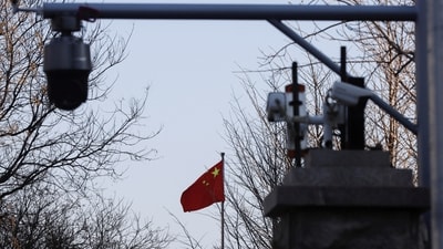 A Chinese flag is seen near surveillance cameras outside the Beijing No. 2 Intermediate People's Court. (REUTERS)