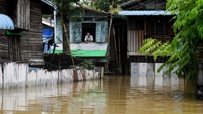 A man looks out from his house in a flooded area following monsoon rains in Bago township, Bago region, (AFP) A man looks out from his house in a flooded area following monsoon rains in Bago township, Bago region, (AFP)