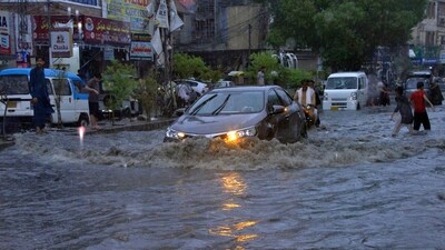 Cars drive through a flooded road caused by heavy monsoon rainfall. (Representative Image/AP) Cars drive through a flooded road caused by heavy monsoon rainfall. (Representative Image/AP)