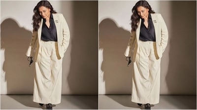 For one of her looks, Rani donned a beige striped Gucci pantsuit featuring an oversized fit, double collar and lapel buttons, which she paired with a black shirt tucked into matching flared trousers. (Instagram/@ranimukherjeeeofficial) For one of her looks, Rani donned a beige striped Gucci pantsuit featuring an oversized fit, double collar and lapel buttons, which she paired with a black shirt tucked into matching flared trousers. (Instagram/@ranimukherjeeeofficial)