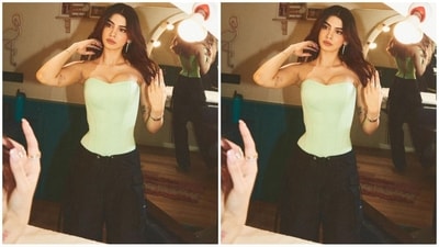 For her look, Khushi chooses a mint green corset top from the shelves of the clothing brand Munique. It features a fitted bodice, plunging neckline, no sleeves and a tie-up pattern at the back.&nbsp; (Instagram/@mohitrai)