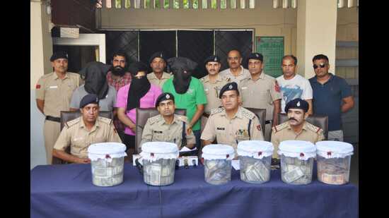 Chandigarh superintendent of police Ketan Bansal (sitting, second from left) giving details of the racket. (HT Photo)
