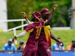 Roston Chase and Jason Holder&nbsp;celebrate the dismissal of Hardik Pandya during the fifth T20I at Central Broward Regional Park in Lauderhill(AP)