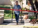 FILE - Investigators remove firearms from a house in the 8500 block of E. Canyon Vista Dr. in Anaheim, Calif., on Aug. 4, 2023. A Southern California judge was charged Friday, Aug. 11, 2023, with murder in the shooting death of his wife and 47 weapons were seized from the house, authorities said. Orange County Superior Court Judge Jeffrey Ferguson, 72, was arrested last week after his adult son called 911 to report his mother, Sheryl Ferguson, had been shot at the family's home in the upscale neighborhood of Anaheim Hills, the district attorney's office said in a statement. (Paul Bersebach/The Orange County Register via AP, File)