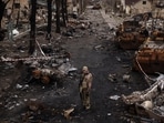 Russia-Ukraine War: A Ukrainian serviceman stands amid destroyed Russian tanks in Bucha, on the outskirts of Kyiv, Ukraine. Russia-Ukraine War: A Ukrainian serviceman stands amid destroyed Russian tanks in Bucha, on the outskirts of Kyiv, Ukraine.