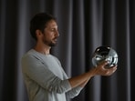 Ricardo Macieira, regional manager, Europe holds the biometric imaging device, the Orb of the identity and financial public utility Worldcoin in his hands, to create a World ID digital passport, being able to trade in cryptocurrency issued, in Berlin, Germany.
