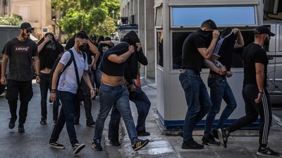 Football fans, most of them from Croatia, cover their faces while leaving the Athens Police Headquarters in Athens, on August 11, 2023, as they are being detained as part of the inquiry on the death of a Greek fan during violent clashes. (AFP) Football fans, most of them from Croatia, cover their faces while leaving the Athens Police Headquarters in Athens, on August 11, 2023, as they are being detained as part of the inquiry on the death of a Greek fan during violent clashes. (AFP)
