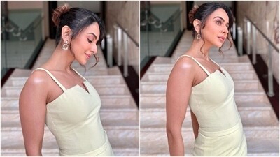 Rakul accessorised the ensemble with nude-coloured pumps and minimal jewels, including double hoop dangling earrings and statement rings. Lastly, for the glam picks, she went for subtle eye shadow, kohl-lined eyes, mascara-adorned eyelashes, darkened brows, a messy updo, blushed cheeks, pink lip shade, and a dewy base. (Instagram) Rakul accessorised the ensemble with nude-coloured pumps and minimal jewels, including double hoop dangling earrings and statement rings. Lastly, for the glam picks, she went for subtle eye shadow, kohl-lined eyes, mascara-adorned eyelashes, darkened brows, a messy updo, blushed cheeks, pink lip shade, and a dewy base. (Instagram)