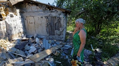 Lyubov Tolchina, 63, reacts next to the damaged house of her son Vitaly, 40, who was killed the day before by shelling in the course of Russia-Ukraine conflict in Donetsk, Russian-controlled Ukraine, August 13. (REUTERS)
