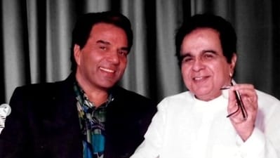 Dharmendra and Dilip Kumar pose together.
