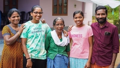 Minnu Mani (second from left) with her family outside her house in Wayanad, Kerala.
