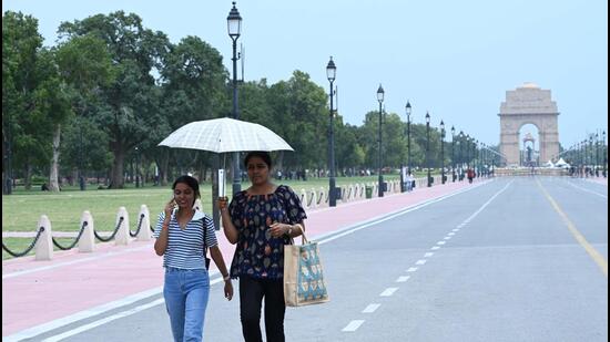 People walk on Kartavya Path during a hot afternoon, in New Delhi on Sunday (Arvind Yadav/HT Photo)