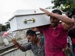 Gilgres Santos, the father of five-year-old Eloah Passos, carries his daughter's remains for a burial at Cacuia Cemetery two days after she was killed by a stray bullet in Rio de Janeiro, Brazil, Monday. Gilgres Santos, the father of five-year-old Eloah Passos, carries his daughter's remains for a burial at Cacuia Cemetery two days after she was killed by a stray bullet in Rio de Janeiro, Brazil, Monday.