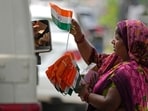 A roadside vendor sells tricolor flags at a traffic intersection ahead of India's Independence Day.
