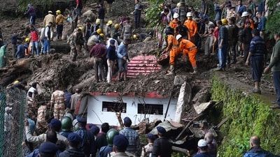 Rescuers remove mud and debris as they search for people feared trapped after a landslide near a temple on the outskirts of Shimla, Himachal Pradesh. (AP) Rescuers remove mud and debris as they search for people feared trapped after a landslide near a temple on the outskirts of Shimla, Himachal Pradesh. (AP)
