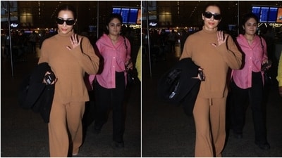 Malaika accessorised the airport look with chunky beige-coloured sneakers, rings, and black-tinted futuristic sunglasses. Lastly, she chose a centre-parted sleek top knot, rose-pink tinted lip shade, rouged cheeks, glowing skin, and feathered brows for the glam picks. (Instagram) Malaika accessorised the airport look with chunky beige-coloured sneakers, rings, and black-tinted futuristic sunglasses. Lastly, she chose a centre-parted sleek top knot, rose-pink tinted lip shade, rouged cheeks, glowing skin, and feathered brows for the glam picks. (Instagram)
