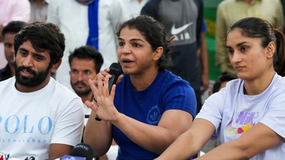Wrestlers Vinesh Phogat (R), Sakshi Malik and Bajrang Punia during a press conference (PTI) Wrestlers Vinesh Phogat (R), Sakshi Malik and Bajrang Punia during a press conference (PTI)