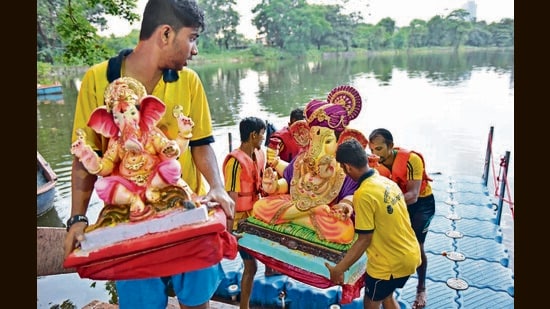 Mumbai, India - September 9, 2016: Men perform immersion of Hindu God Ganesh on fifth day of the ganesh festival at a lake in Aarey colony in Mumbai, India, on Friday, September 9, 2016. (Photo by Pratham Gokhale/ Hindustan Times) (Pratham Gokhale/HT PHOTO)