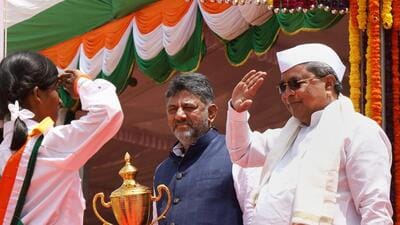 Chief Minister Siddaramaiah and the Deputy Chief Minister DK Shivakumar present a trophy to the best dance performer during the 77th Independence Day celebration at Manekshaw Parade Ground, in Bengaluru, Tuesday. (PTI) Chief Minister Siddaramaiah and the Deputy Chief Minister DK Shivakumar present a trophy to the best dance performer during the 77th Independence Day celebration at Manekshaw Parade Ground, in Bengaluru, Tuesday. (PTI)