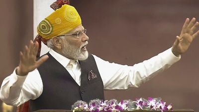 PM Modi wore a multicoloured Rajasthani-style turban as he delivered his speech from the ramparts of Red Fort. The multi-coloured turban with a long tail in PM Modi's carefully chosen Independence Day attire accompanied his off-white kurta, white pants, and a jacket with a pocket square. (PTI) PM Modi wore a multicoloured Rajasthani-style turban as he delivered his speech from the ramparts of Red Fort. The multi-coloured turban with a long tail in PM Modi's carefully chosen Independence Day attire accompanied his off-white kurta, white pants, and a jacket with a pocket square. (PTI)