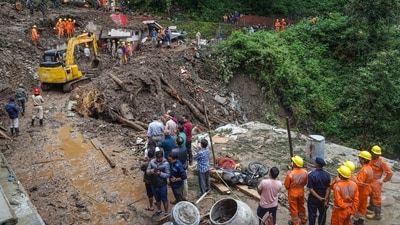 Rescue workers search for people feared missing in landslides following torrential rains, in Shimla, (PTI) Rescue workers search for people feared missing in landslides following torrential rains, in Shimla, (PTI)
