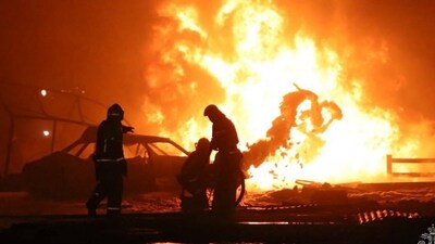 Rescuers pushing out a fire at a gas station in the city of Makhachkala, (AFP)
