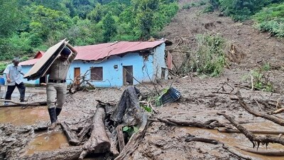 A security personnel carries the belongings of a villager from the site of a landslide after heavy rains at Jadon village in Solan district. (AFP) A security personnel carries the belongings of a villager from the site of a landslide after heavy rains at Jadon village in Solan district. (AFP)