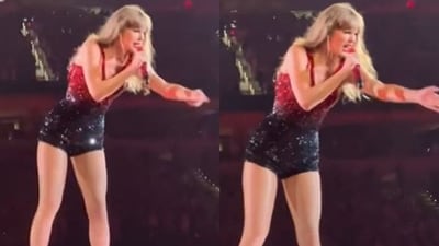 Taylor Swift talks to security during her show. Taylor Swift talks to security during her show.
