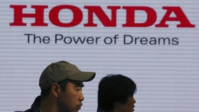 Visitors walk through a showroom of the Honda Motor Co. (Representational/AP File Photo) Visitors walk through a showroom of the Honda Motor Co. (Representational/AP File Photo)